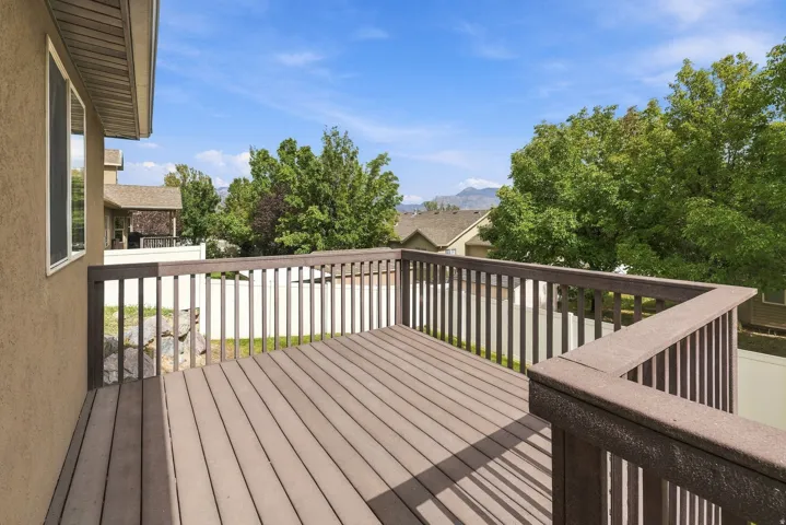 Outdoor deck with composite decking and railing, and surrounding mature trees