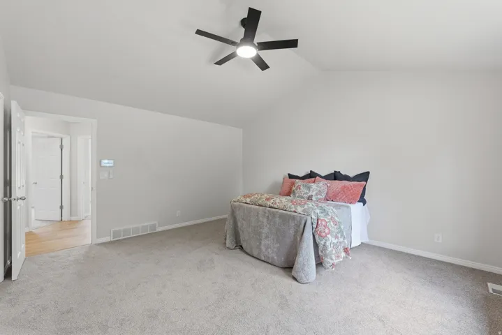 Primary bedroom with vaulted ceiling and ensuite bath