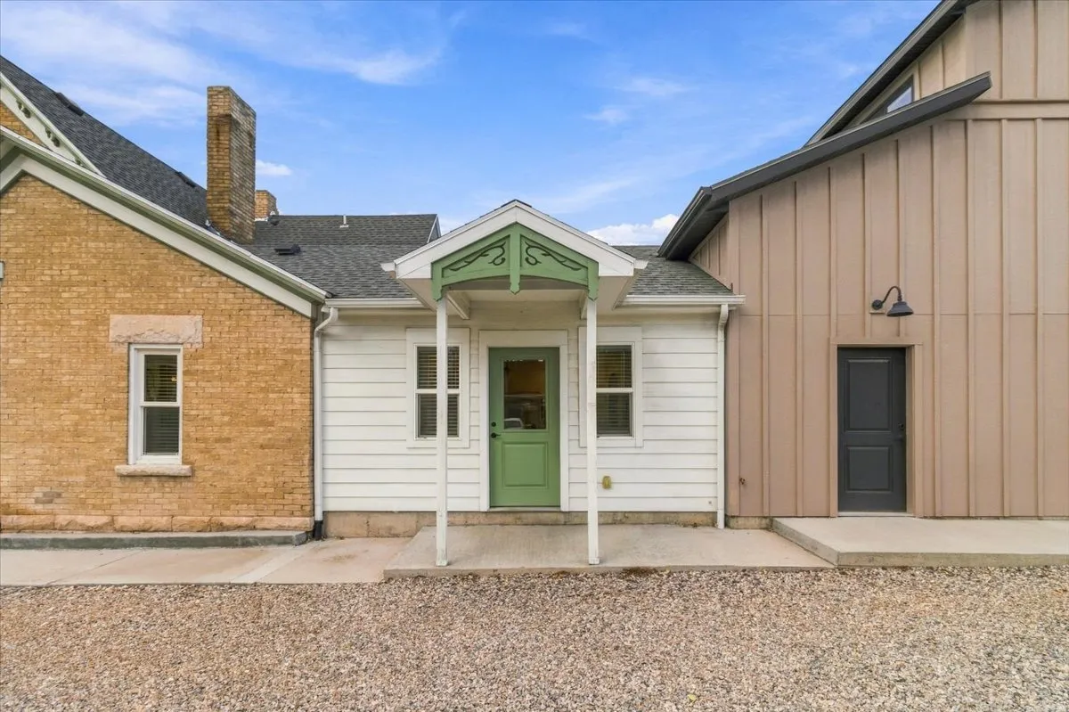 Brick and horizontal siding exterior with a dark shingle roof