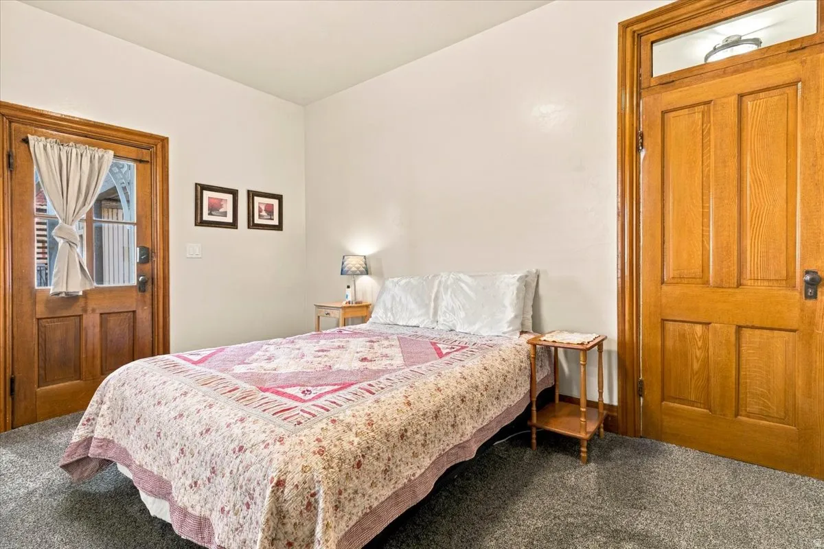 Hardwood paneled doors, transom window, and neutral wall paint