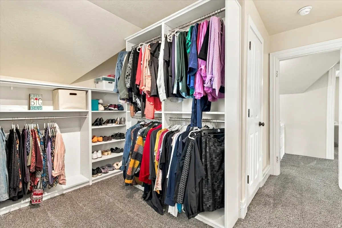 Built-in closet organization system with multiple hanging rods and shelving