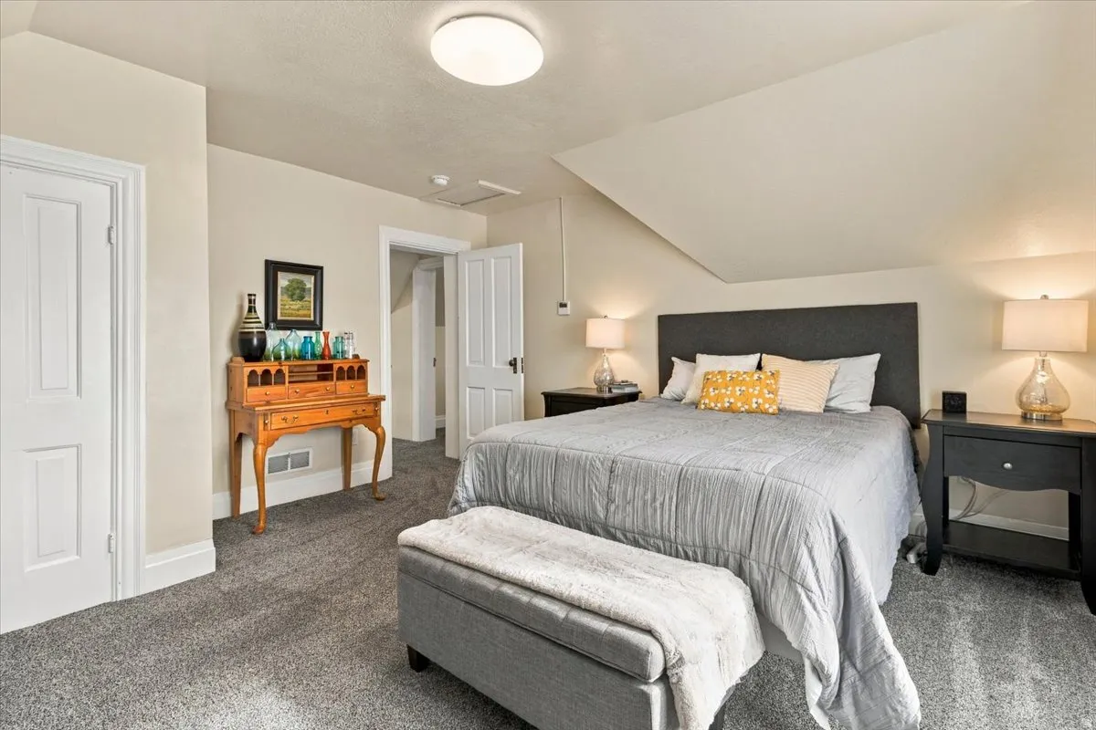 Carpeted flooring, vaulted ceiling, and recessed ceiling light