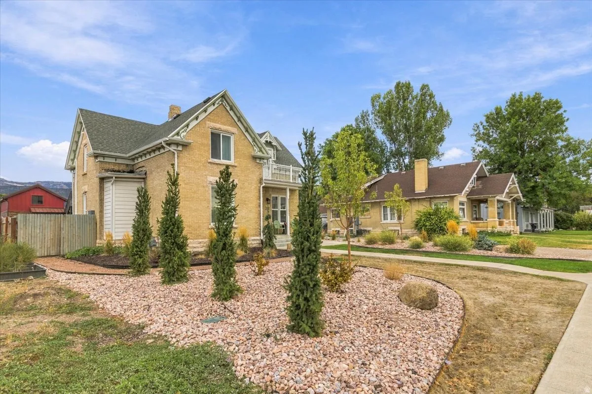 Brick exterior with decorative gables and white trim, featuring a covered porch