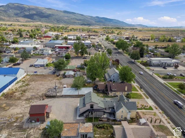 Mountain backdrop framing a mixed-use neighborhood with established residences and commercial properties