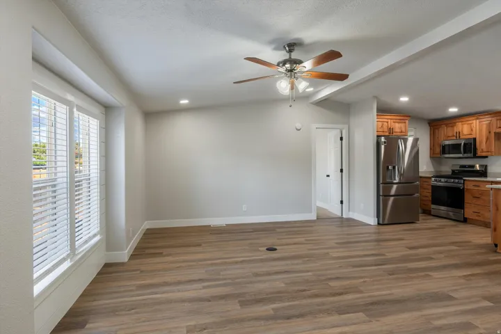 Spacious interior with wood-finish flooring, recessed lighting, and a ceiling fan