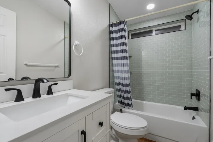 White vanity with matte black hardware, single undermount sink, and matte black faucet