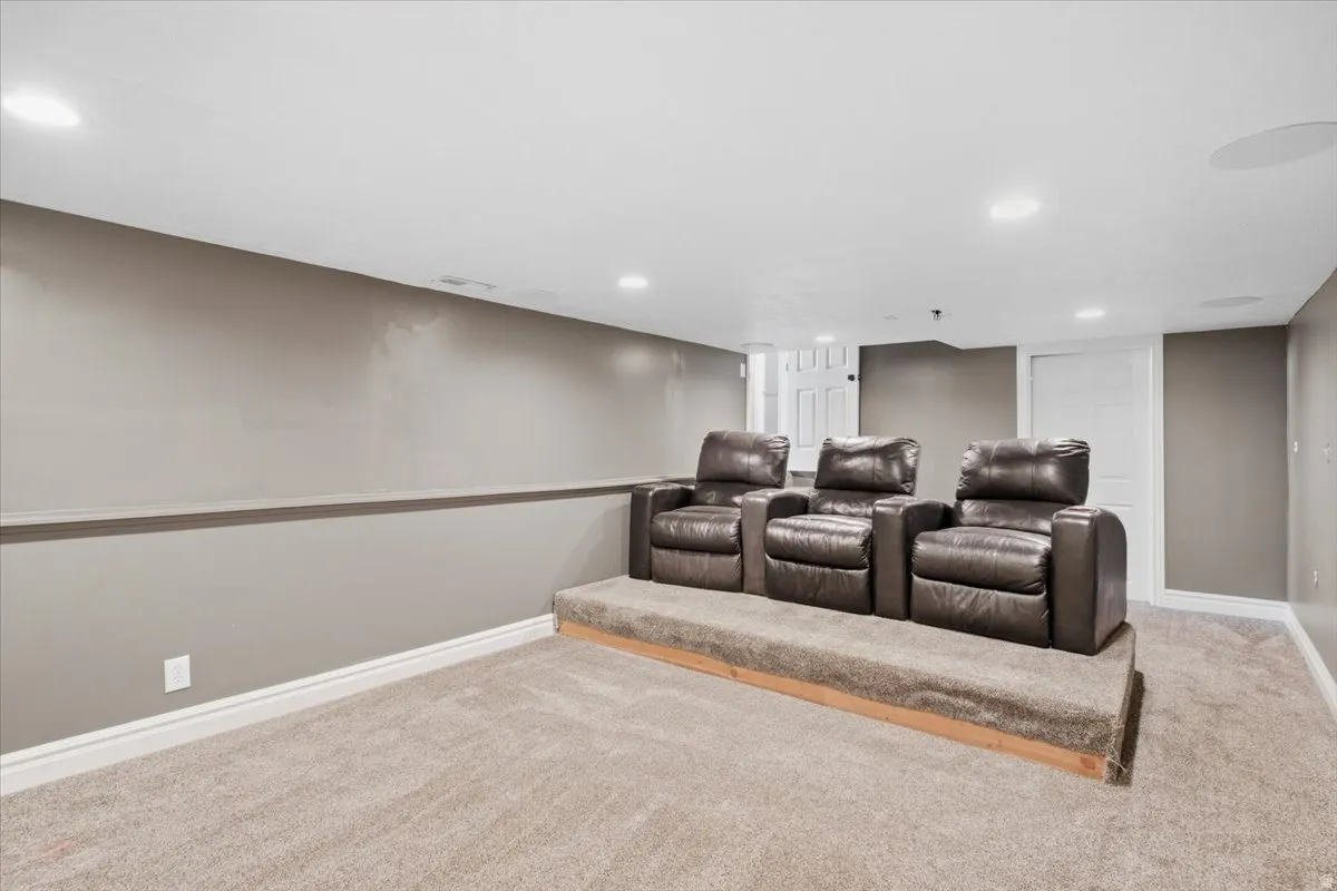 Carpeted tiered seating platform with recessed lighting and built-in ceiling speakers