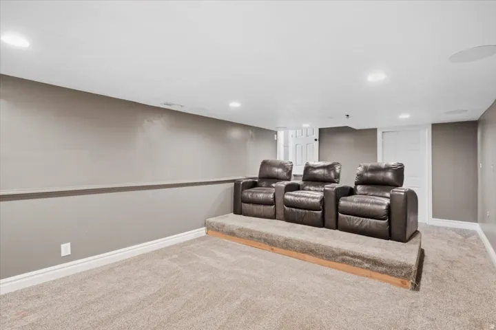Carpeted tiered seating platform with recessed lighting and built-in ceiling speakers