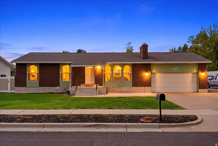 Brick exterior with a shingle roof and arched windows