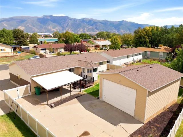 Mountain backdrop, detached garage, paved driveway, carport, fenced perimeter