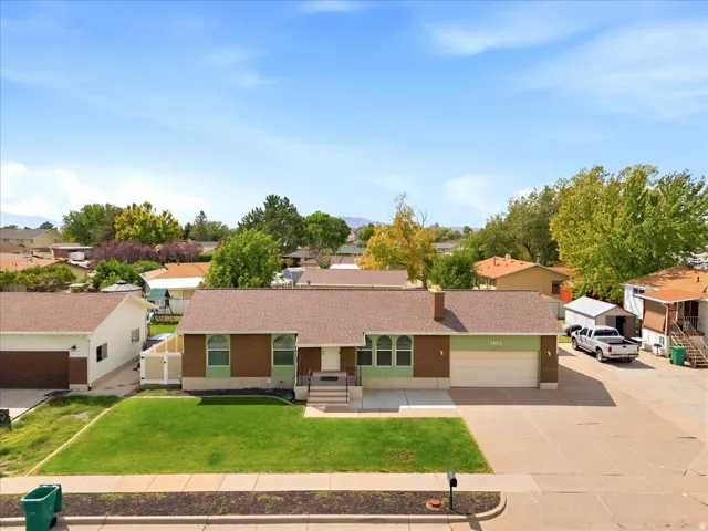 Single-story residence featuring a brown shingle roof and a two-car attached garage
