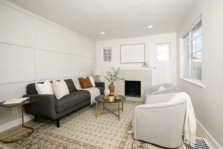 Accent wall with panel molding, fireplace with mantel, recessed lighting, and multiple windows