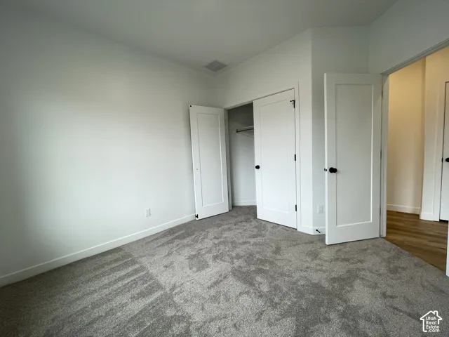Bedroom 2, plush wall-to-wall carpeting, and shaker-style interior doors with matte black hardware