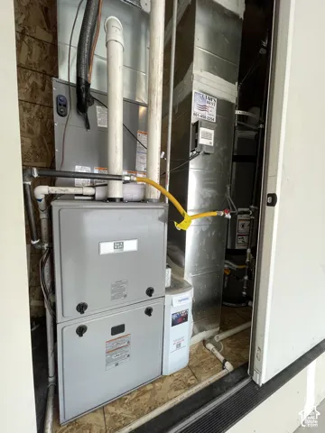 Forced Air High Efficiency furnace, High Efficiency oversized air filter system, and water heater housed within a utility closet in garage