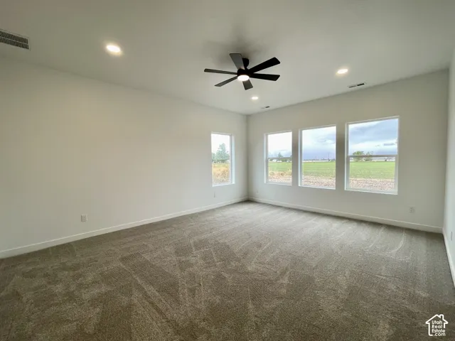 Primary Bedroom, Neutral-toned wall-to-wall carpeting, recessed ceiling lighting, matte black multi-blade ceiling fan, and large windows providing natural light