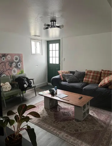 Recessed window, modern ceiling light fixture, paneled door with glass inserts, and wood-finish flooring