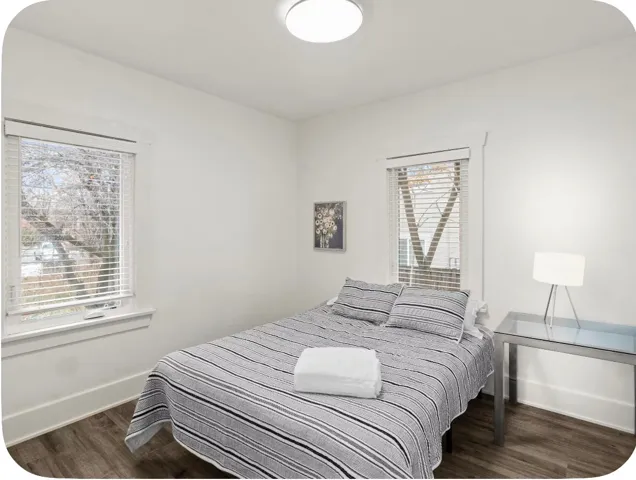 Recessed lighting, wood-finish flooring, and white trim