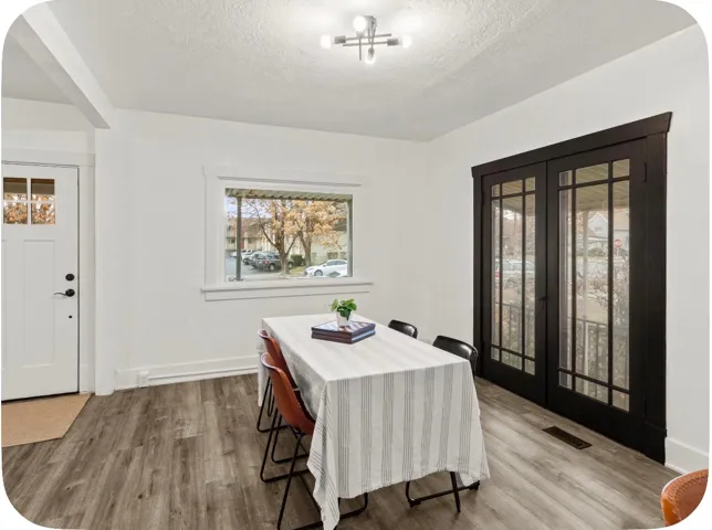 Wood-finish flooring, white walls, and a contemporary ceiling light fixture