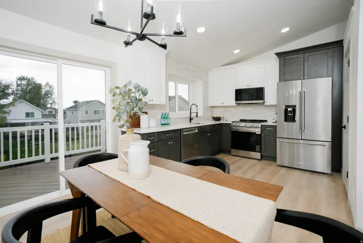 Open-concept kitchen and dining area with wood-finish flooring
