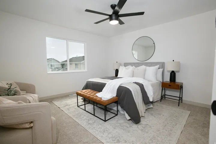 Recessed lighting, ceiling fan with integrated light fixture, large window, and light-toned carpeting