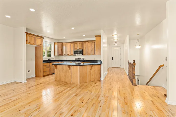Kitchen featuring wood cabinetry, dark countertops, and stainless steel appliances
