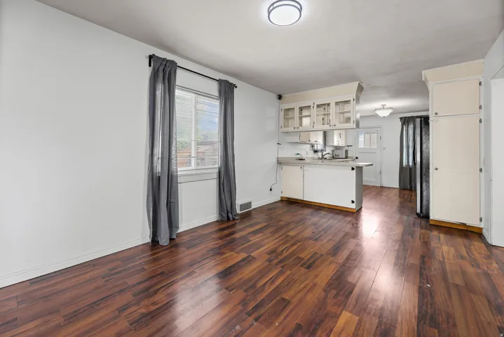 Dining Area off Kitchen – A versatile dining space with rich wood-toned flooring sits just steps from the kitchen, offering a comfortable spot for everyday meals.