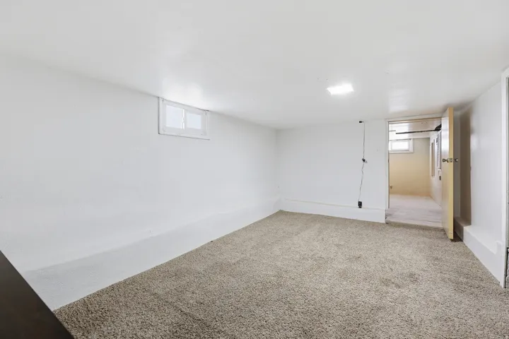 Basement Room – An unfinished basement space with a private entry door, offering excellent potential for future customization or storage.Recessed lighting, carpeted flooring, and a single window