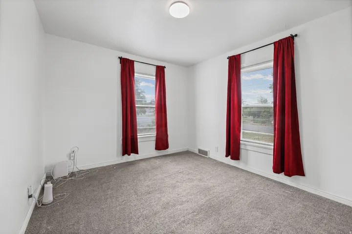 Bedroom – Bright and spacious, this bedroom offers tall dual windows for excellent natural light along with fresh, neutral carpet throughout.