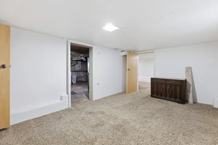 Basement Flex Space – Another versatile finished basement room connecting to utility access, ideal for a home gym, office, or additional storage.