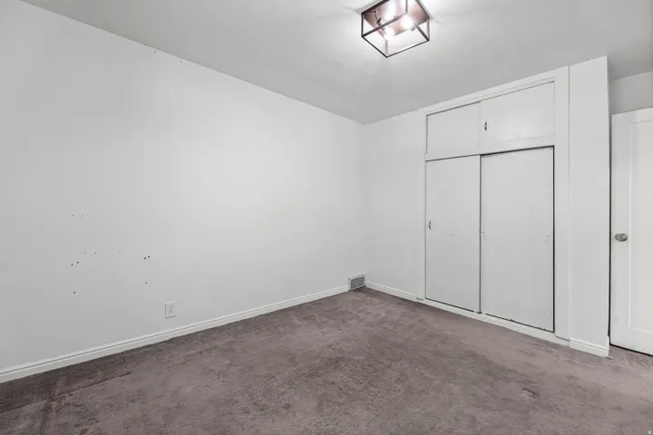 Bedroom with Closet – This carpeted bedroom includes a full sliding-door closet, offering practical storage just steps from the hallway.