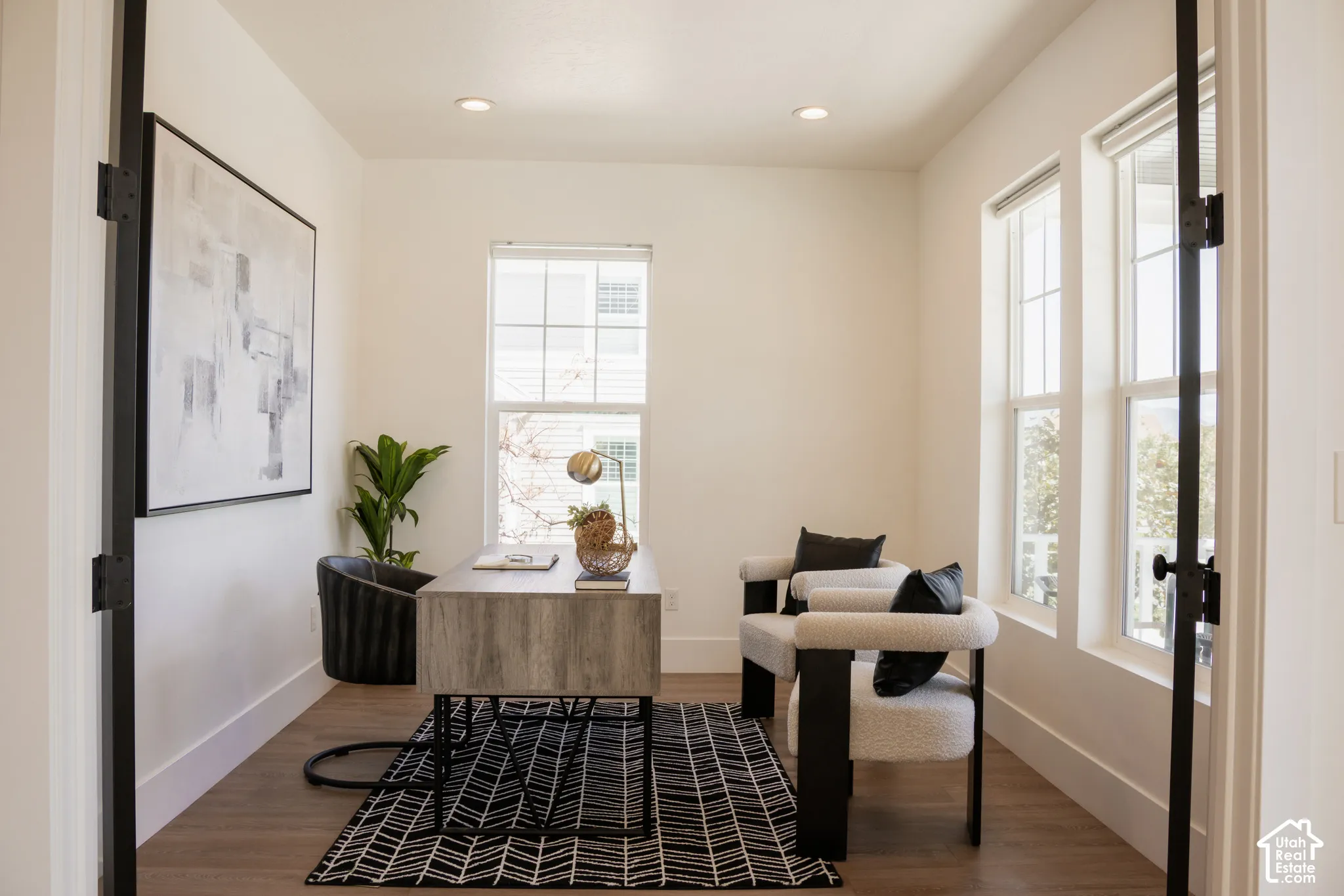 Recessed lighting, wood-finish flooring, and white walls