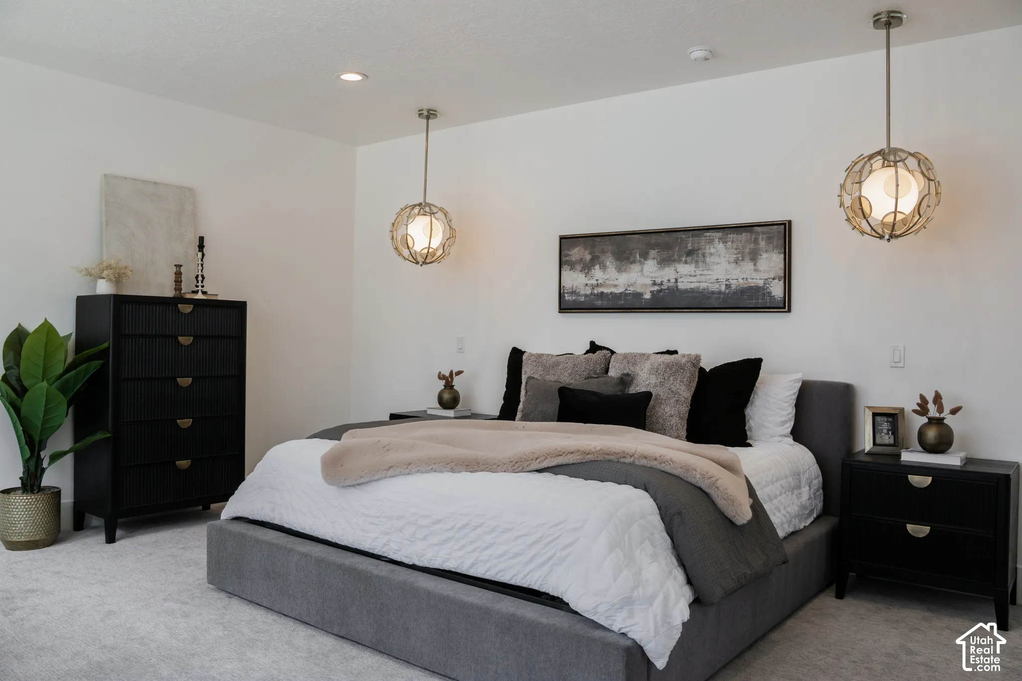 Recessed ceiling lighting, textured wall-mounted pendant lights, light-toned carpeting, and a neutral wall palette