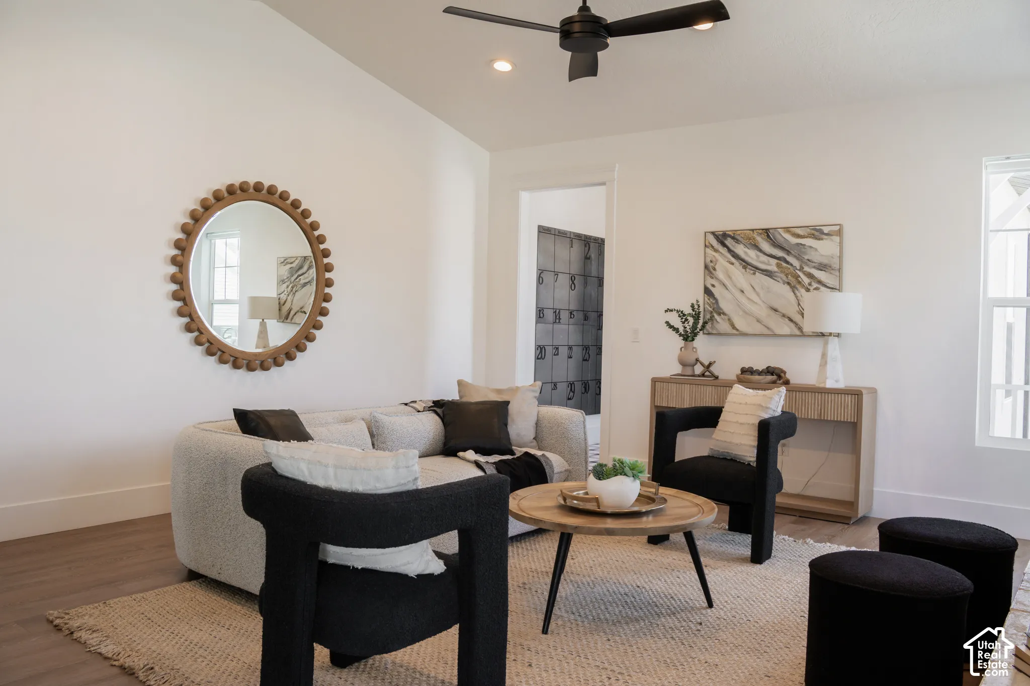 Vaulted ceiling with a ceiling fan, recessed lighting, wood-finish flooring, and white walls
