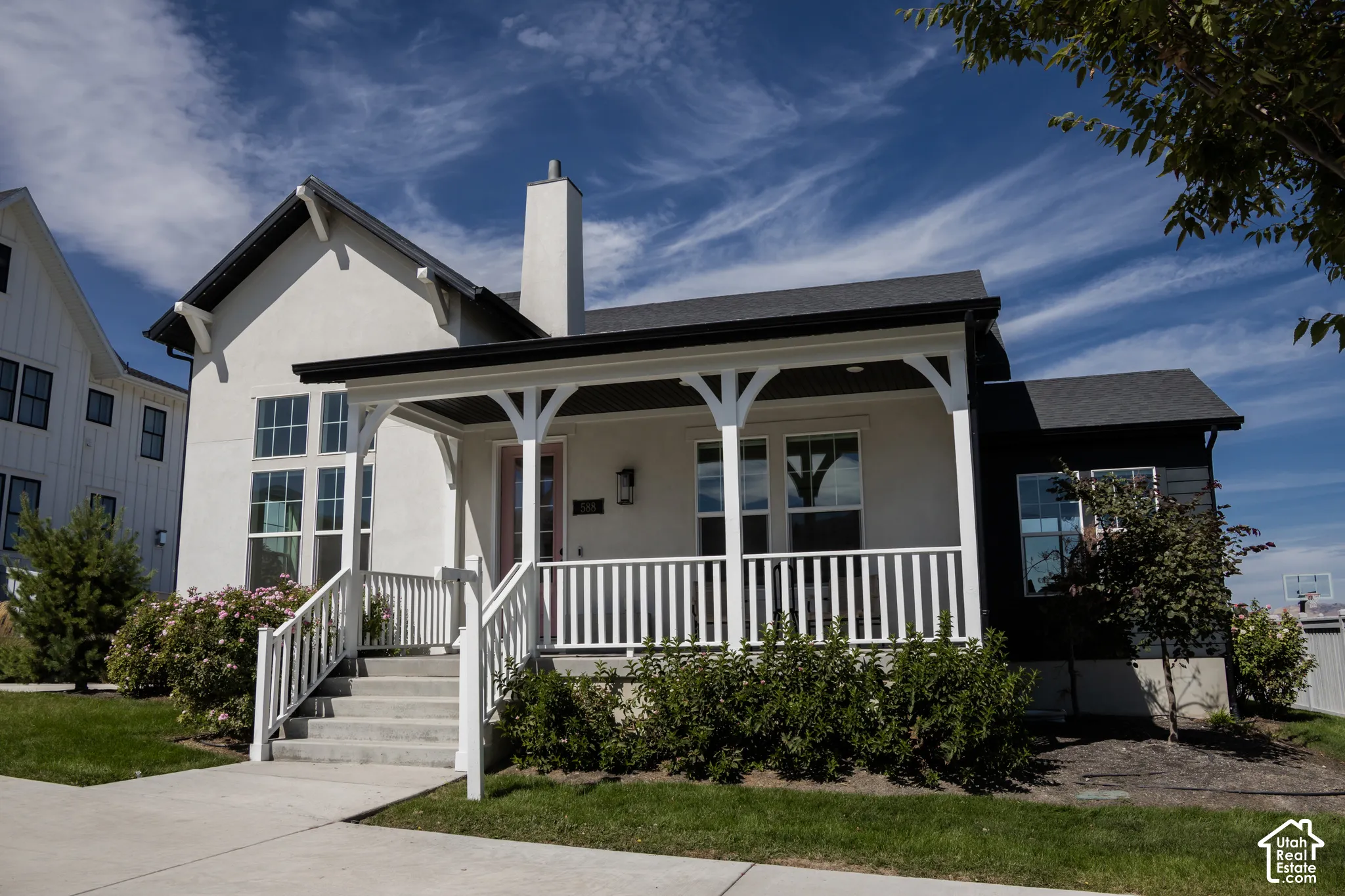 White stucco exterior with dark trim accents