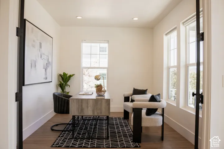 Recessed lighting, wood-finish flooring, and white walls