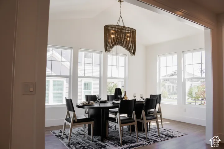 Dining area featuring a vaulted ceiling and an ornate chandelier