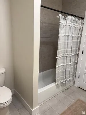 Tub and shower combination with tile surround and tiled flooring
