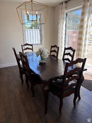 Wood-finish flooring with a multi-light geometric chandelier, featuring a glass sliding door and a single-pane window