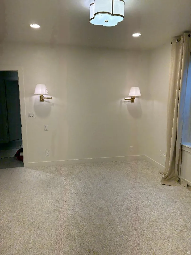Recessed ceiling lighting, flush mount ceiling fixture, wall sconces, wall-to-wall carpeting, and window with drapes