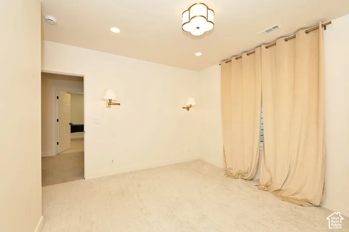 Interior space featuring recessed lighting, a quatrefoil-style semi-flush mount fixture, and two wall-mounted sconces