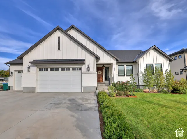 Modern farmhouse exterior featuring vertical board-and-batten siding, a concrete driveway, a three-car garage, and a covered entryway