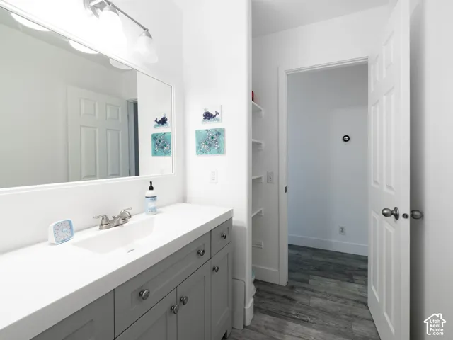 Vanity with a white countertop and undermount sink