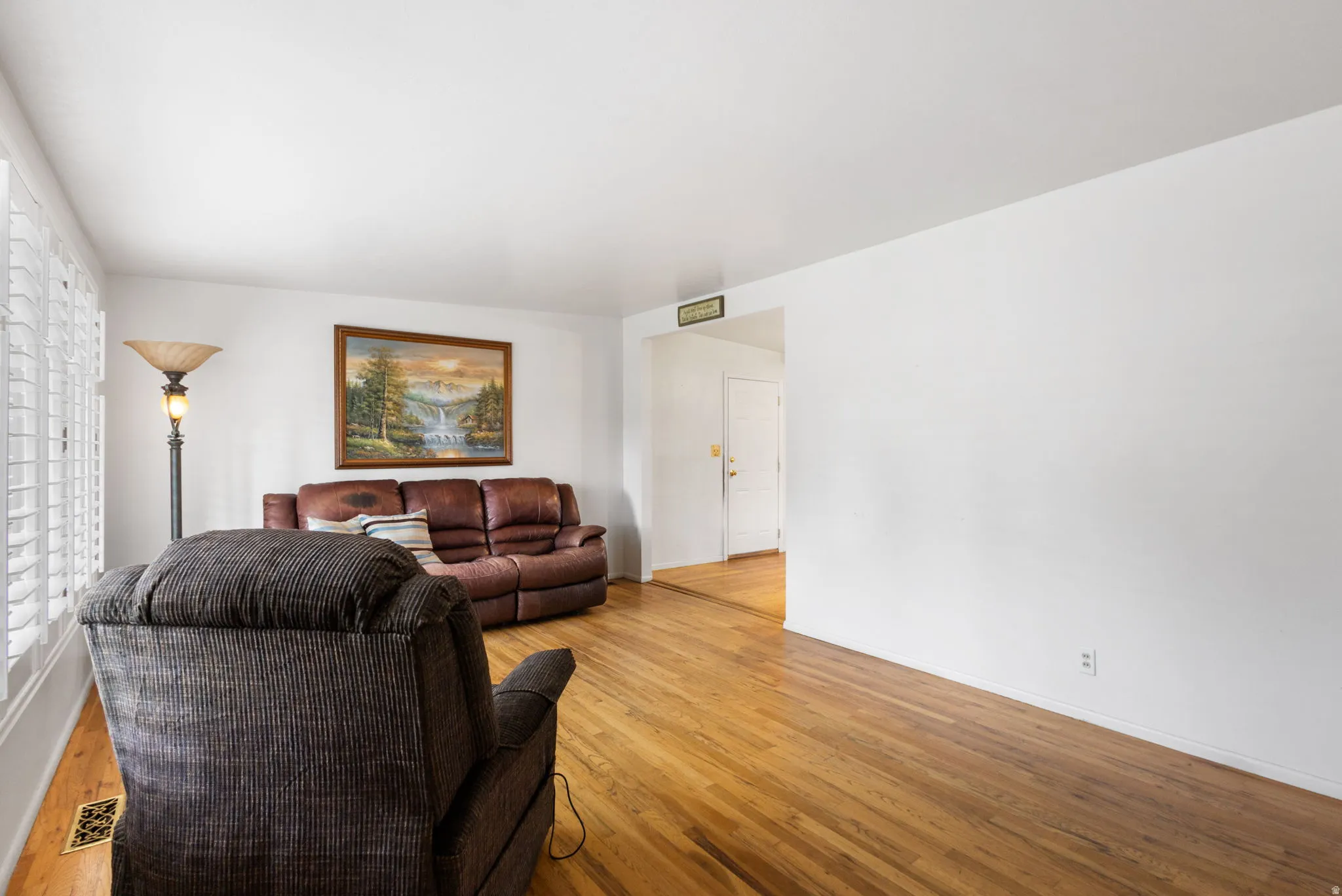 Hardwood flooring, crisp white walls, and bright overhead lighting