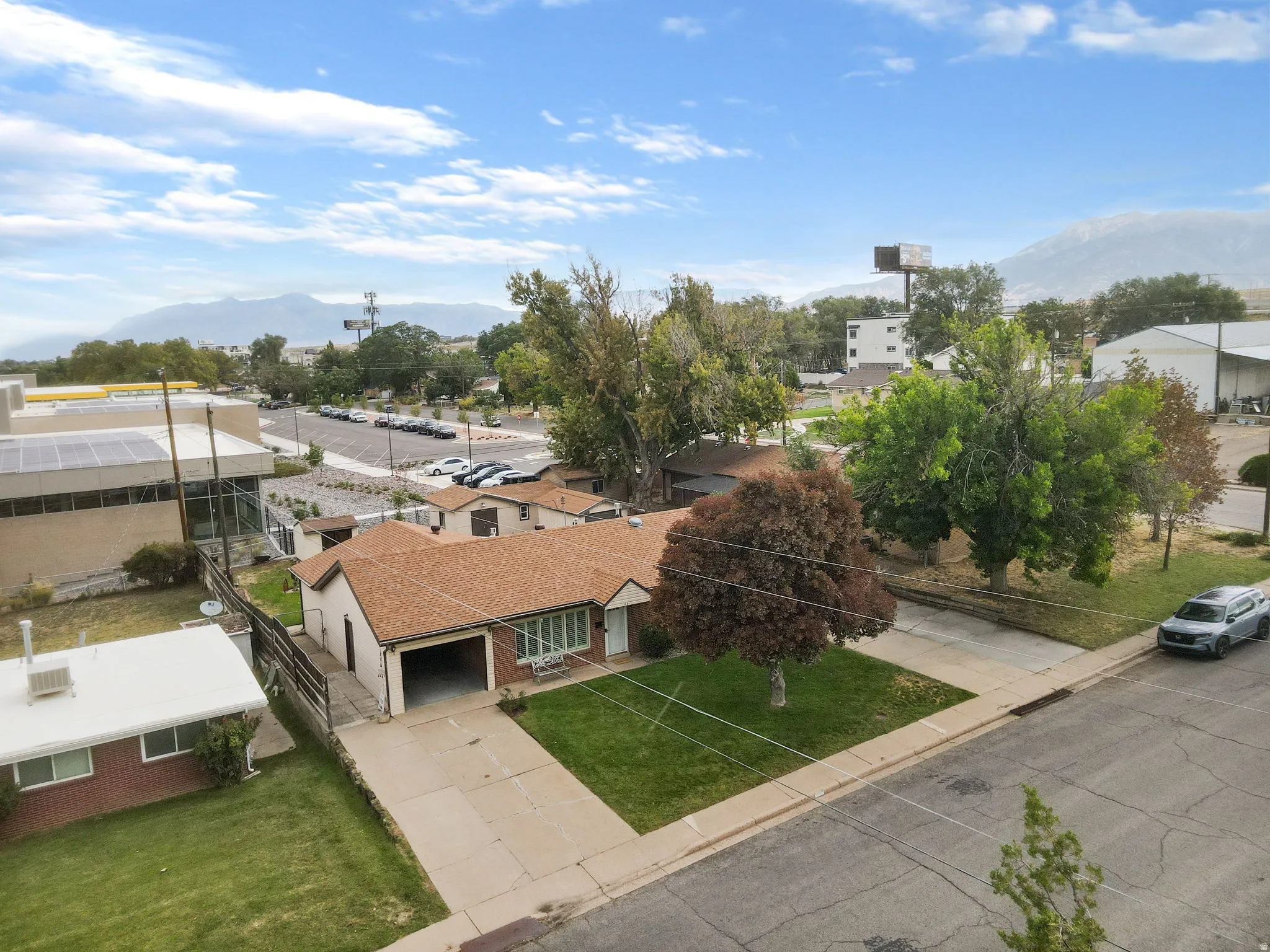Single-story residence with a brown shingle roof, attached garage, and a concrete driveway
