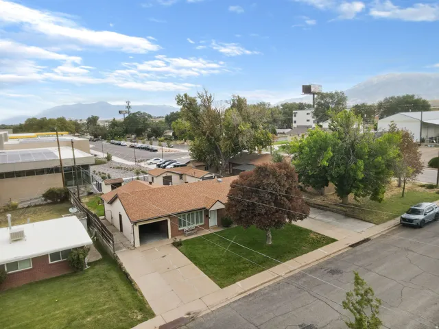 Single-story residence with a brown shingle roof, attached garage, and a concrete driveway