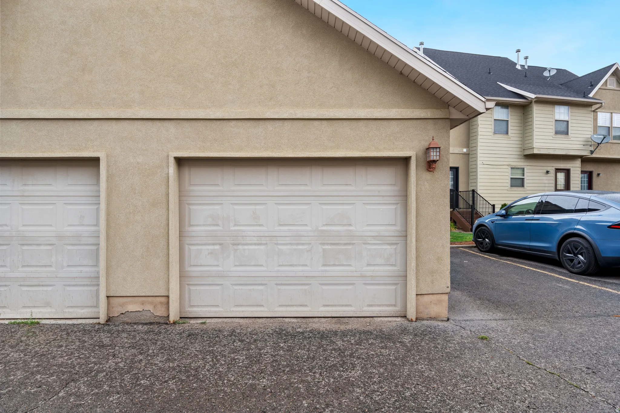 Two panel garage doors with stucco exterior