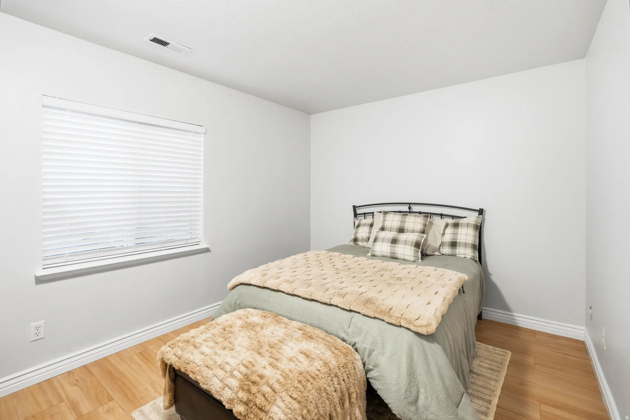 Neutral wall color, wood-finish flooring, and white trim