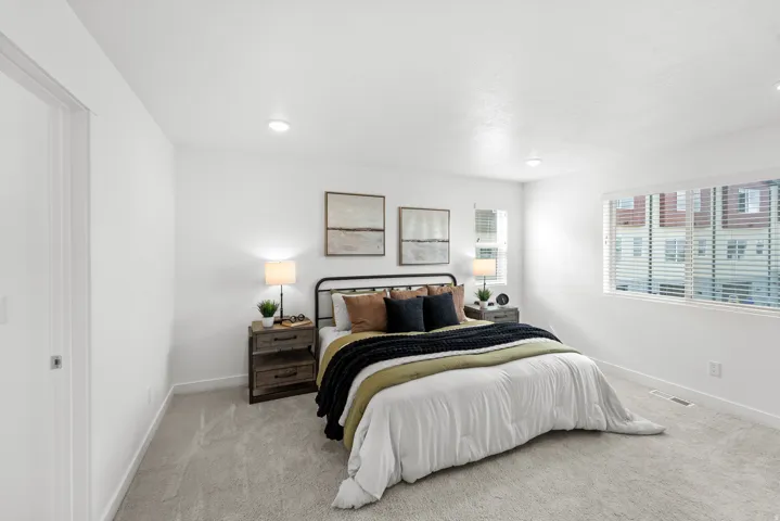 White walls, recessed lighting, and light-toned carpeting
