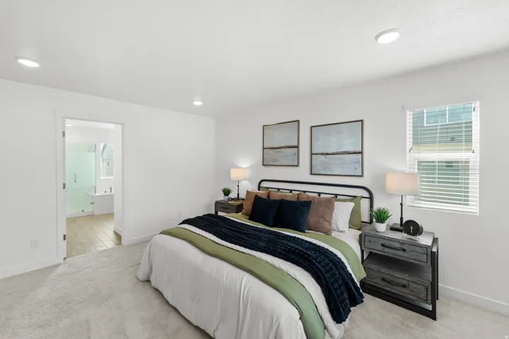 Recessed ceiling lighting, a window with blinds, and light-toned carpeting