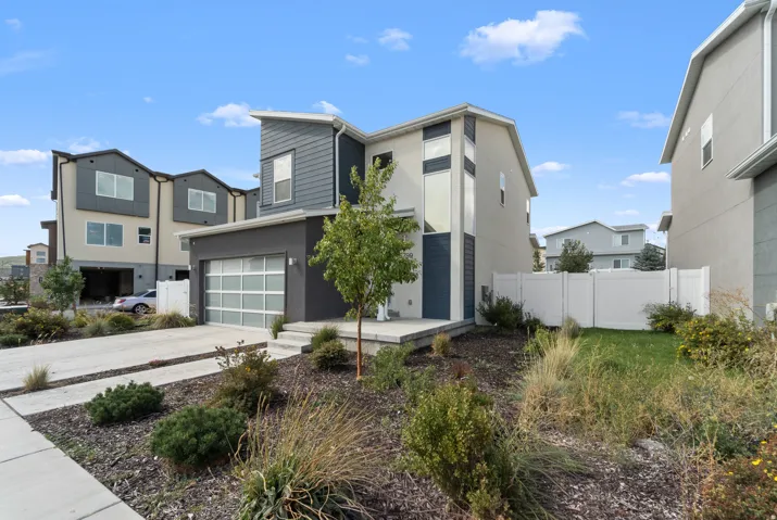 Modern exterior with a contrasting façade, integrated garage with a frosted panel door, and an architectural entry